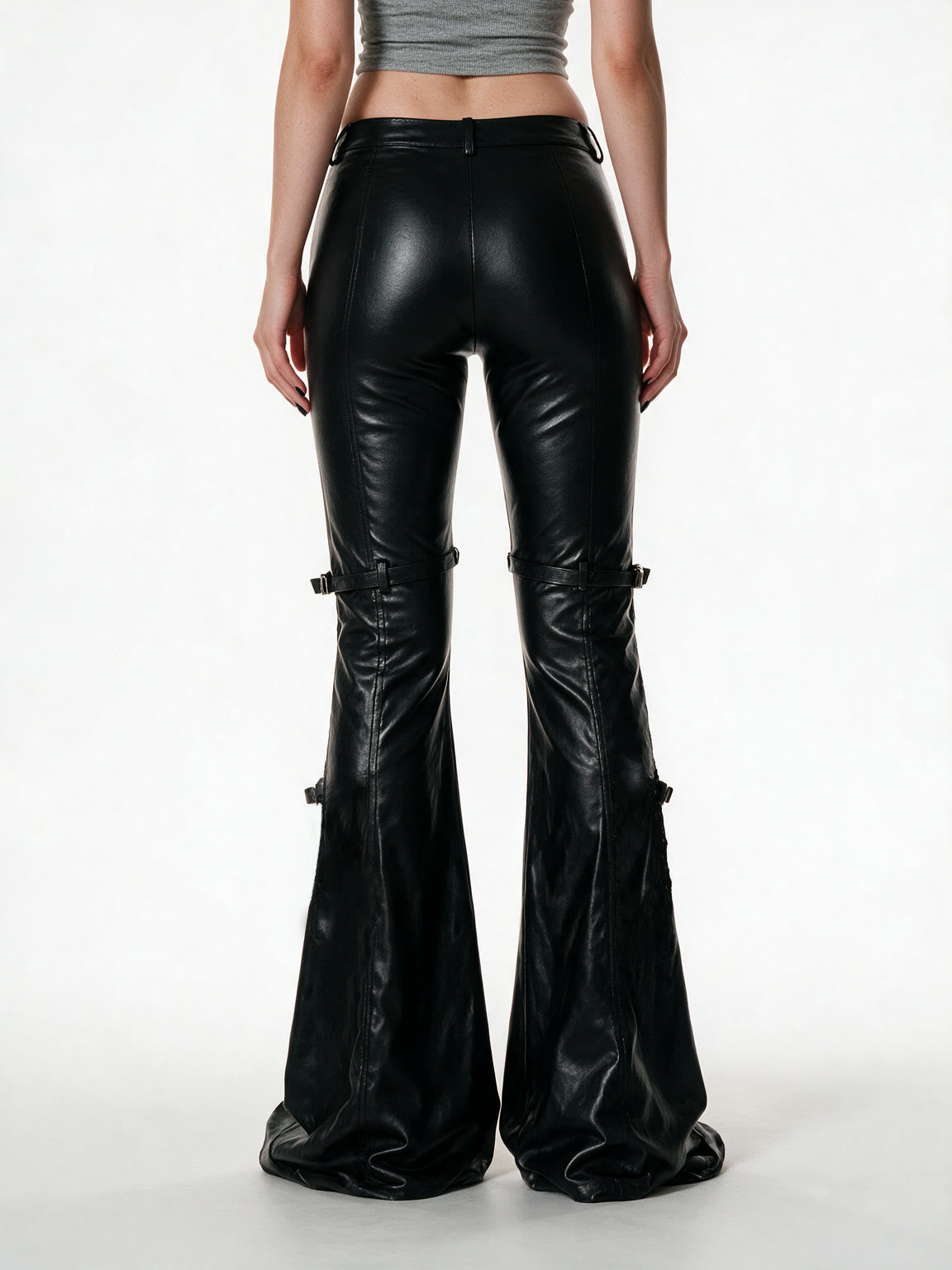 Black faux leather flare trousers with knee buckle straps