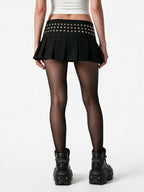 Black pleated mini skirt with a studded yoke