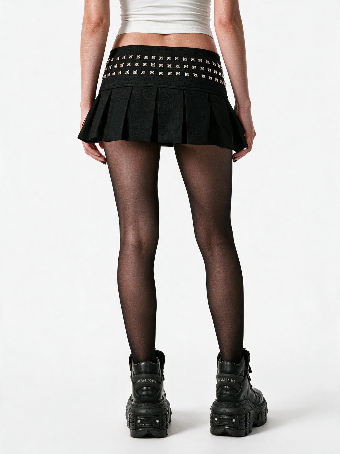 Black pleated mini skirt with a studded yoke