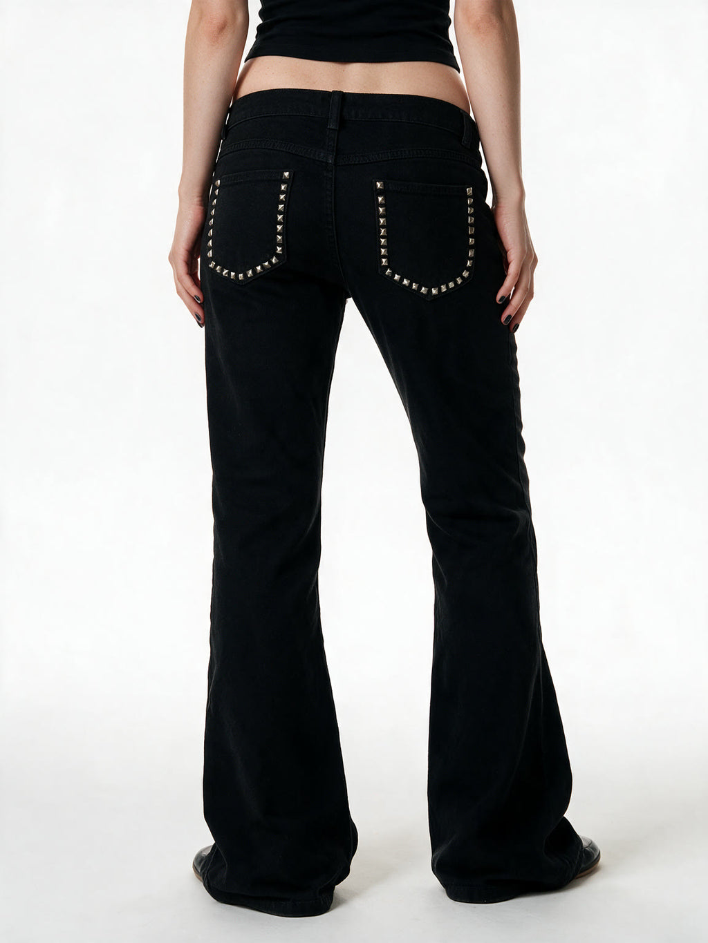 Black low rise flare jeans with a studded waistband