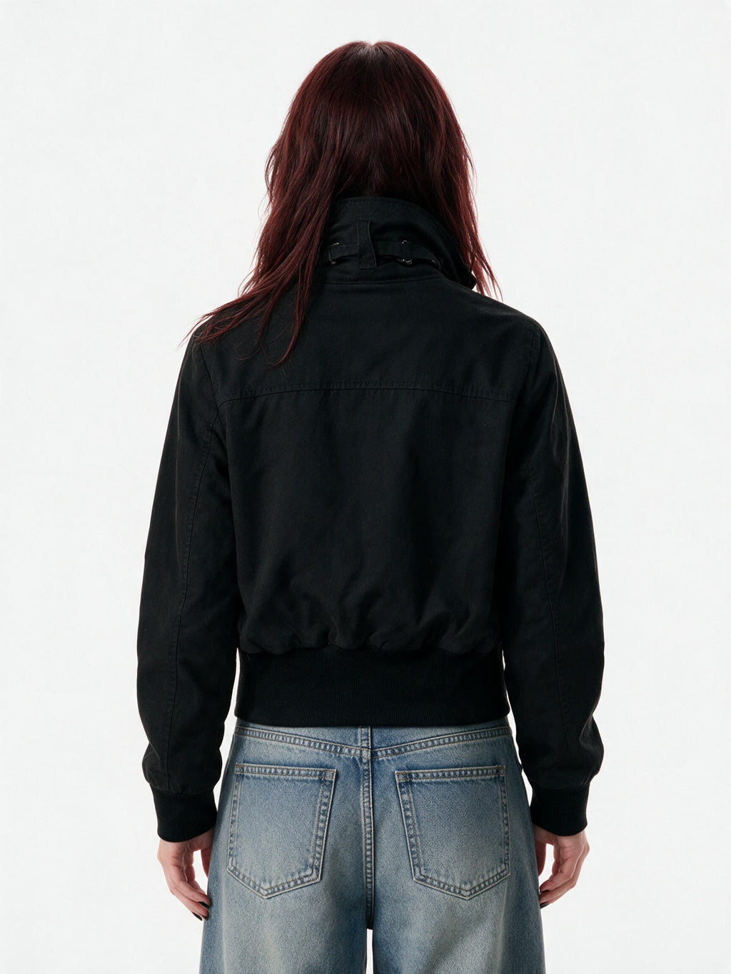 Cropped black bomber jacket with a studded buckled collar