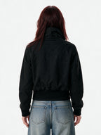 Cropped black bomber jacket with a studded buckled collar