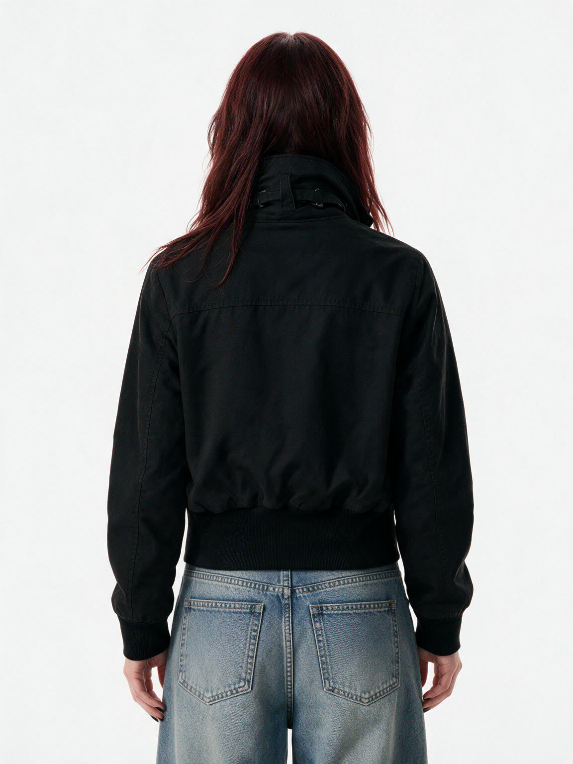 Cropped black bomber jacket with a studded buckled collar