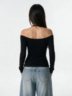 Black long sleeve top with a pinned lace panel and cross prints