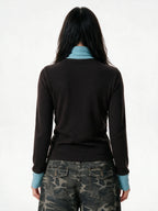 Brown turtleneck long sleeve top with pale blue cuffs