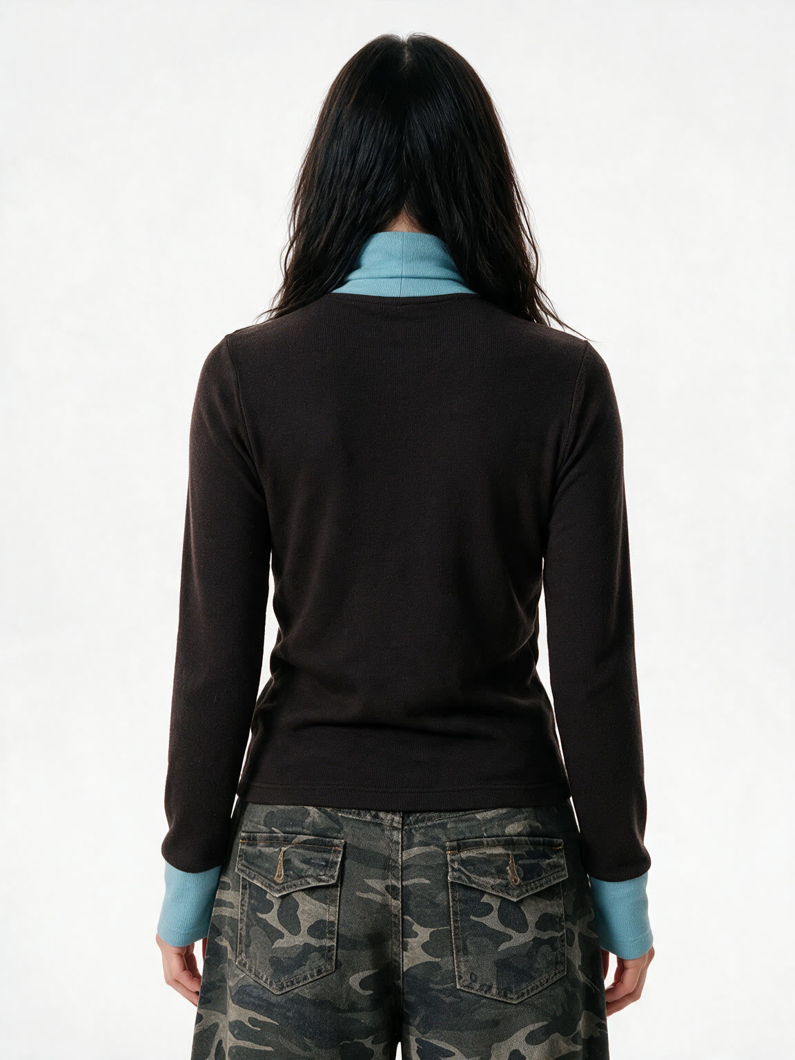 Brown turtleneck long sleeve top with pale blue cuffs