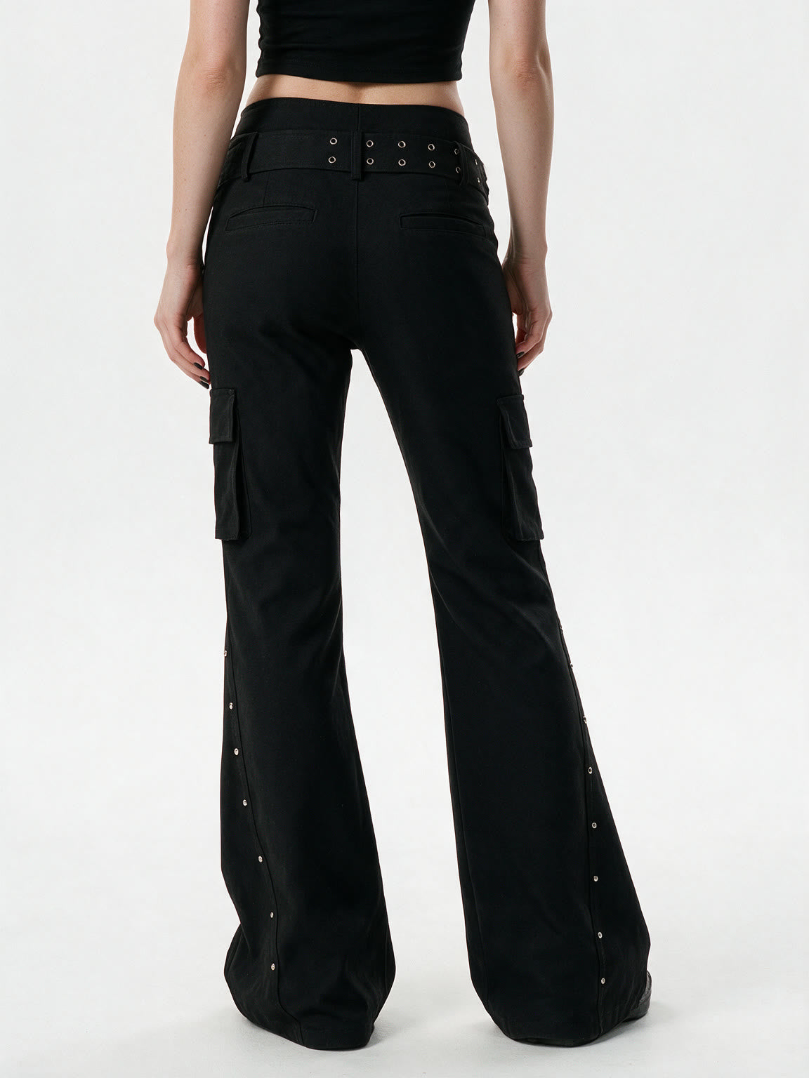 Black cargo flare trousers with rivets and a studded belt