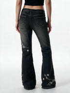 Washed black flare jeans with pale floral embroidery