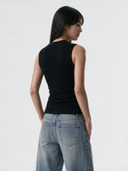 Black bustier tank with safety pins and a studded cross