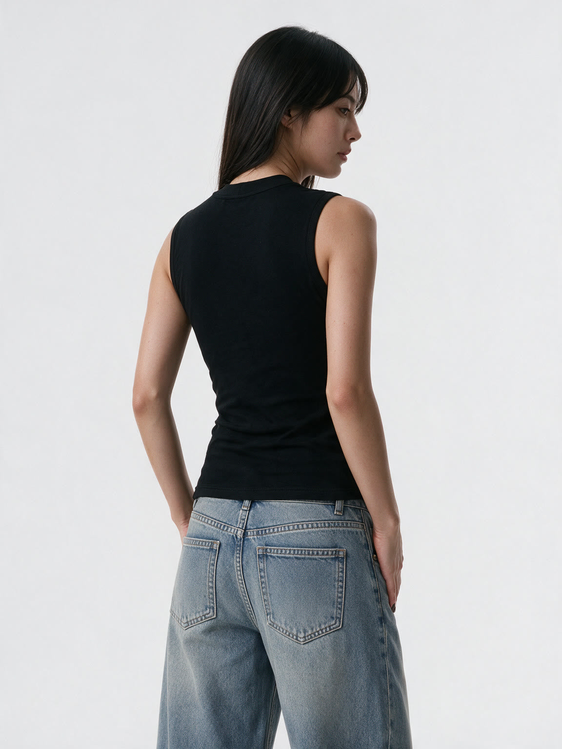 Black bustier tank with safety pins and a studded cross