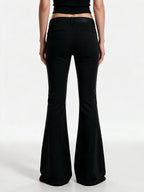 Black high waist flare trousers with a studded belt