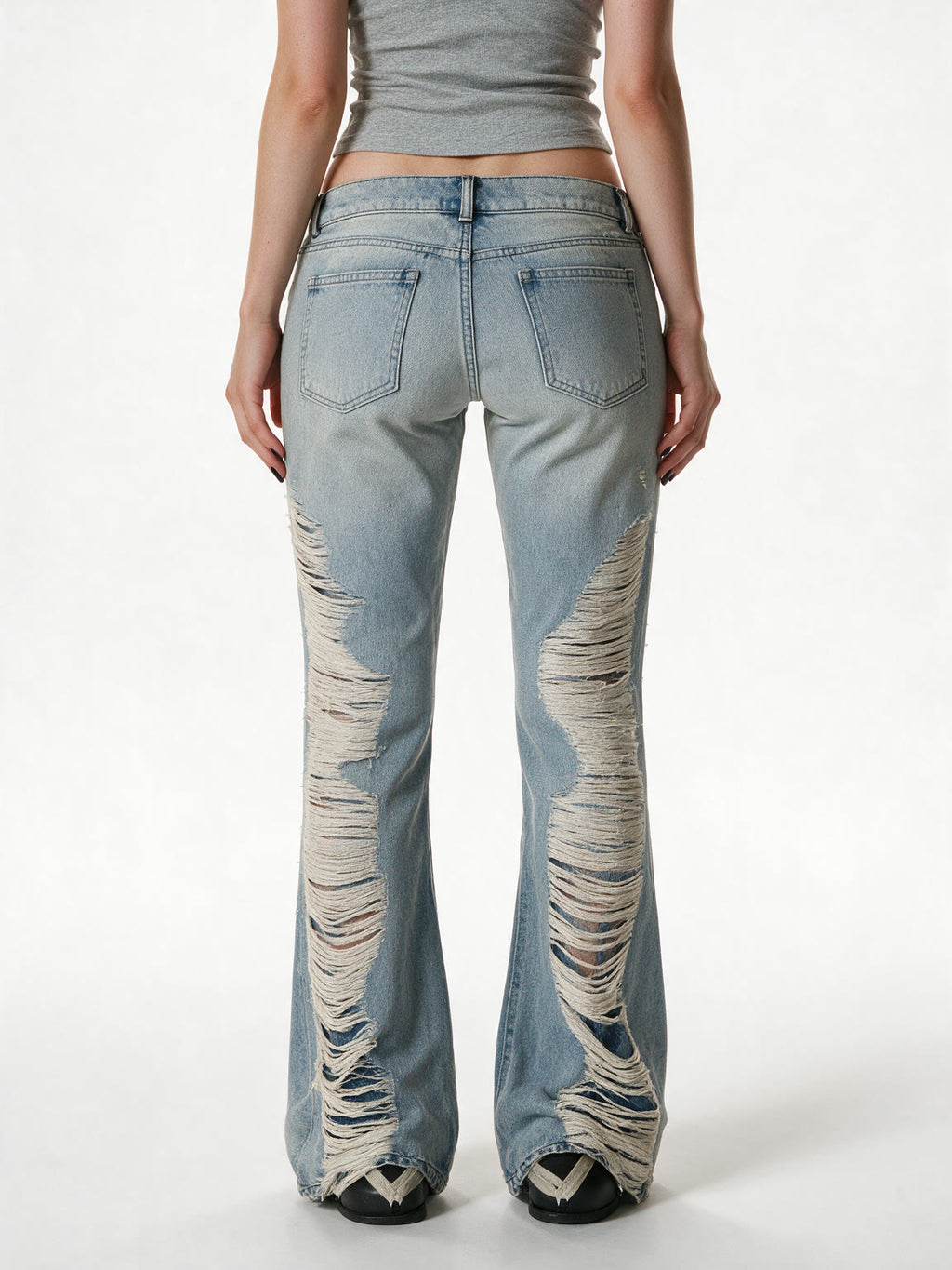 Light wash destroyed flare jeans with shredded legs