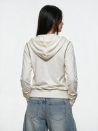 White zip hoodie with a cross print and ruched sleeves