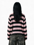 Oversized pink and black striped distressed knit sweater