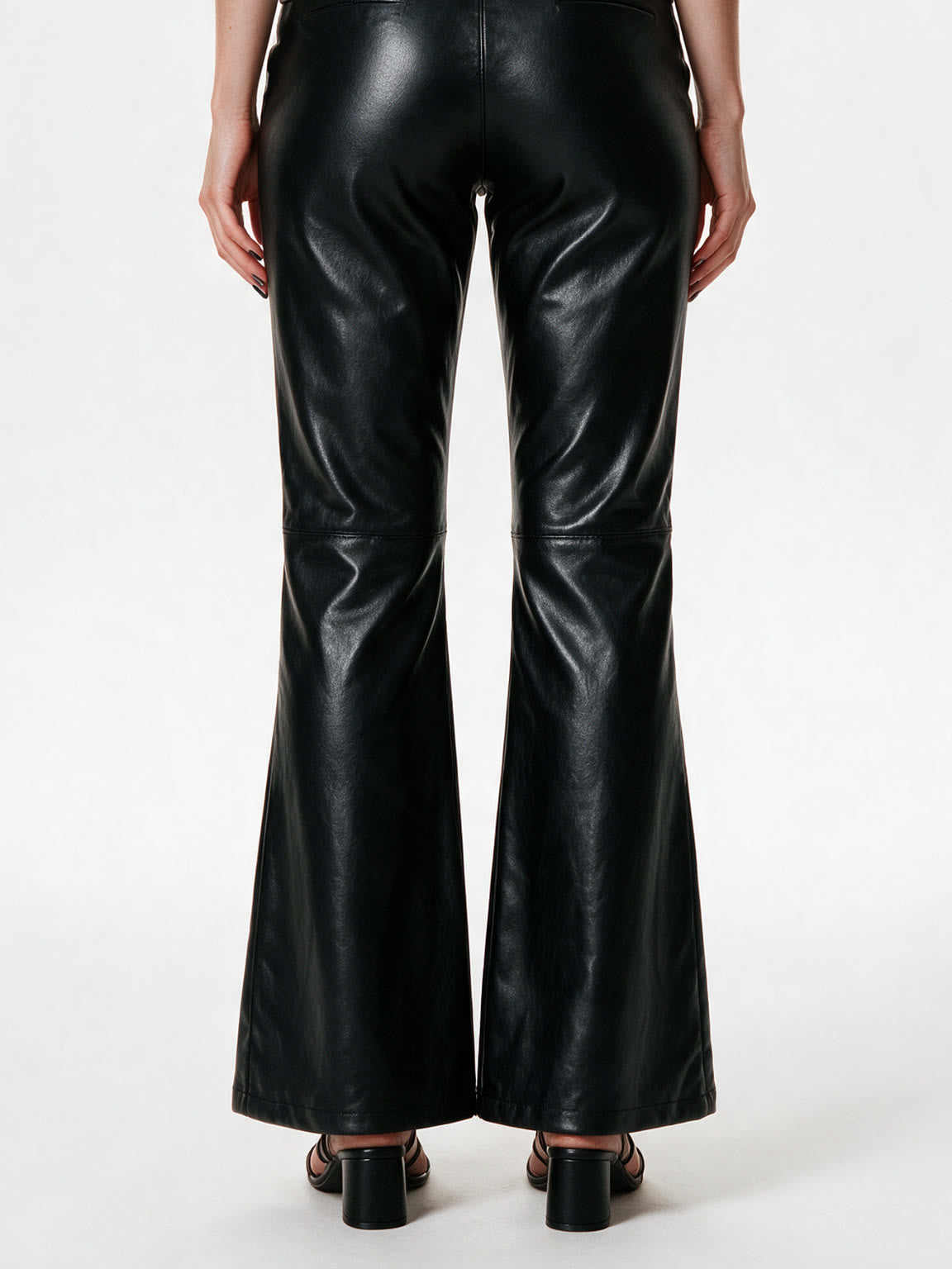 Black faux leather flare trousers with knee buckle straps
