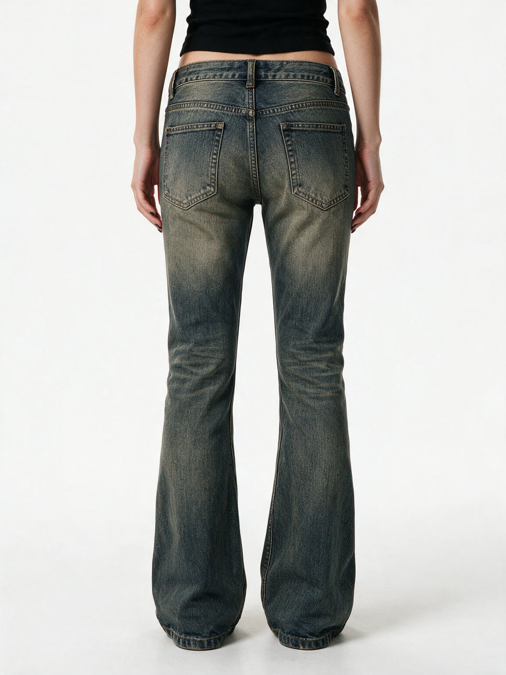 Washed blue flare jeans with a cross patch on the leg