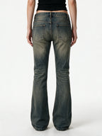 Washed blue flare jeans with a cross patch on the leg