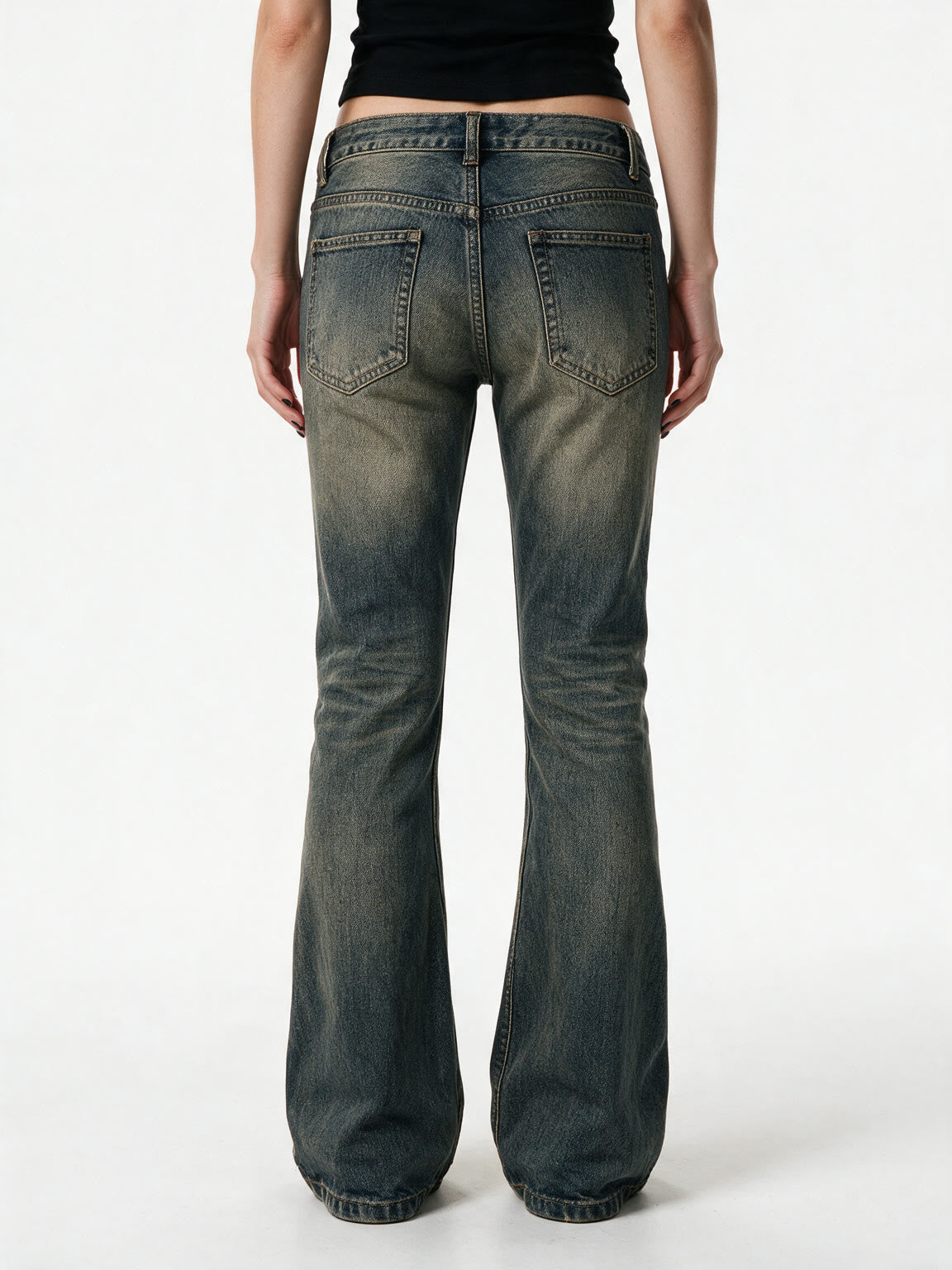 Washed blue flare jeans with a cross patch on the leg