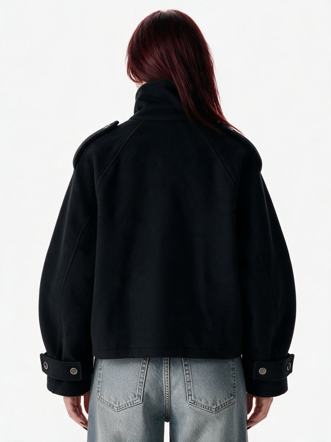 Cropped black wool jacket with buckled cuffs and a high collar