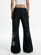 Black flare jeans with white filigree embroidery