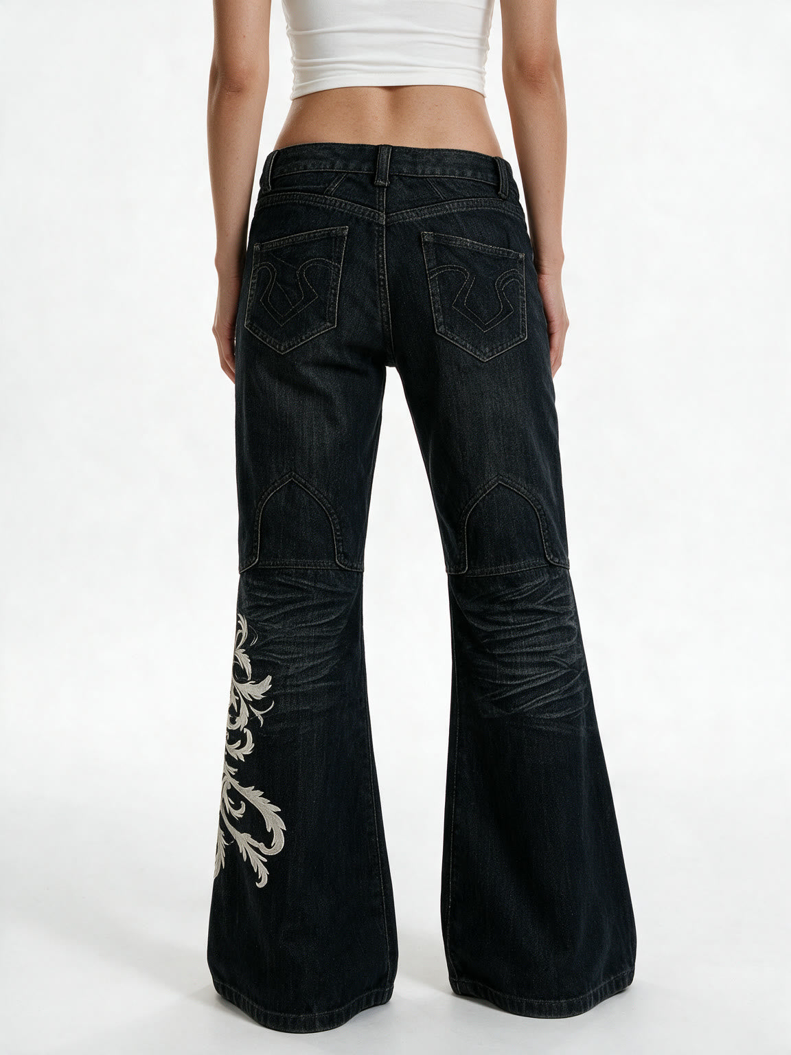 Black flare jeans with white filigree embroidery