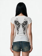 Washed white tee with a winged cross print