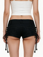 Black denim shorts with side lacing and skull studs