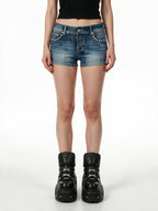 Washed blue denim shorts with rivets and winged embroidery