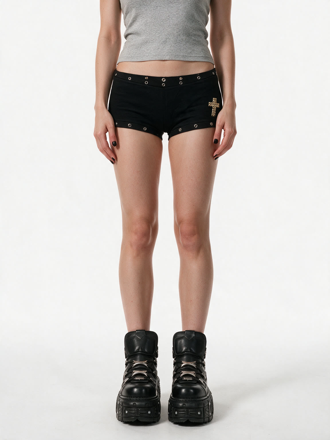 Black micro shorts with grommets and a gold cross