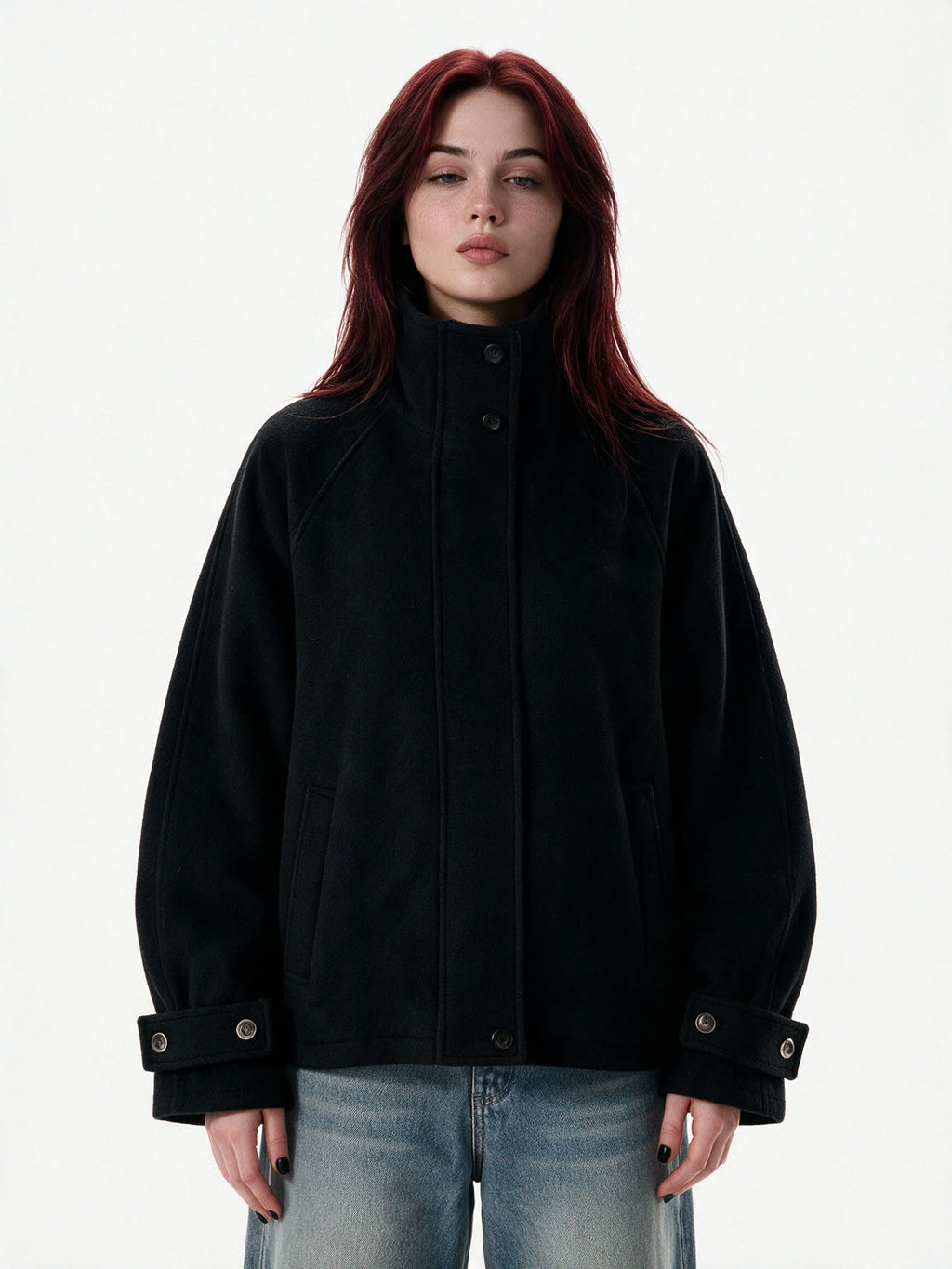 Cropped black wool jacket with buckled cuffs and a high collar