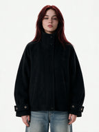 Cropped black wool jacket with buckled cuffs and a high collar