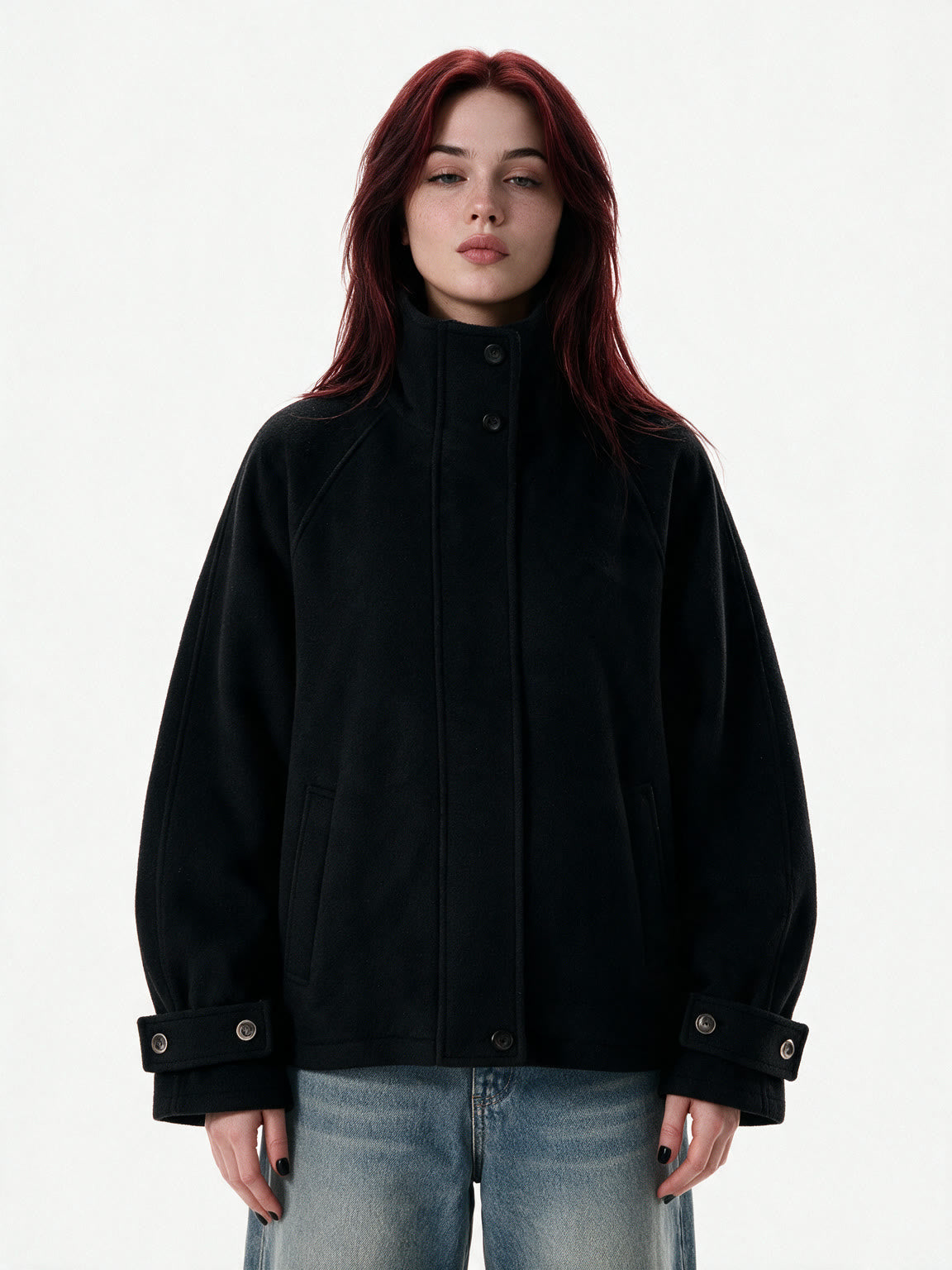 Cropped black wool jacket with buckled cuffs and a high collar