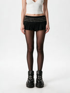 Black pleated mini skirt with a studded yoke