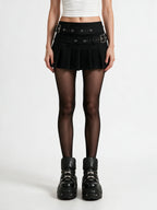 Black pleated mini skirt with two buckled eyelet belts
