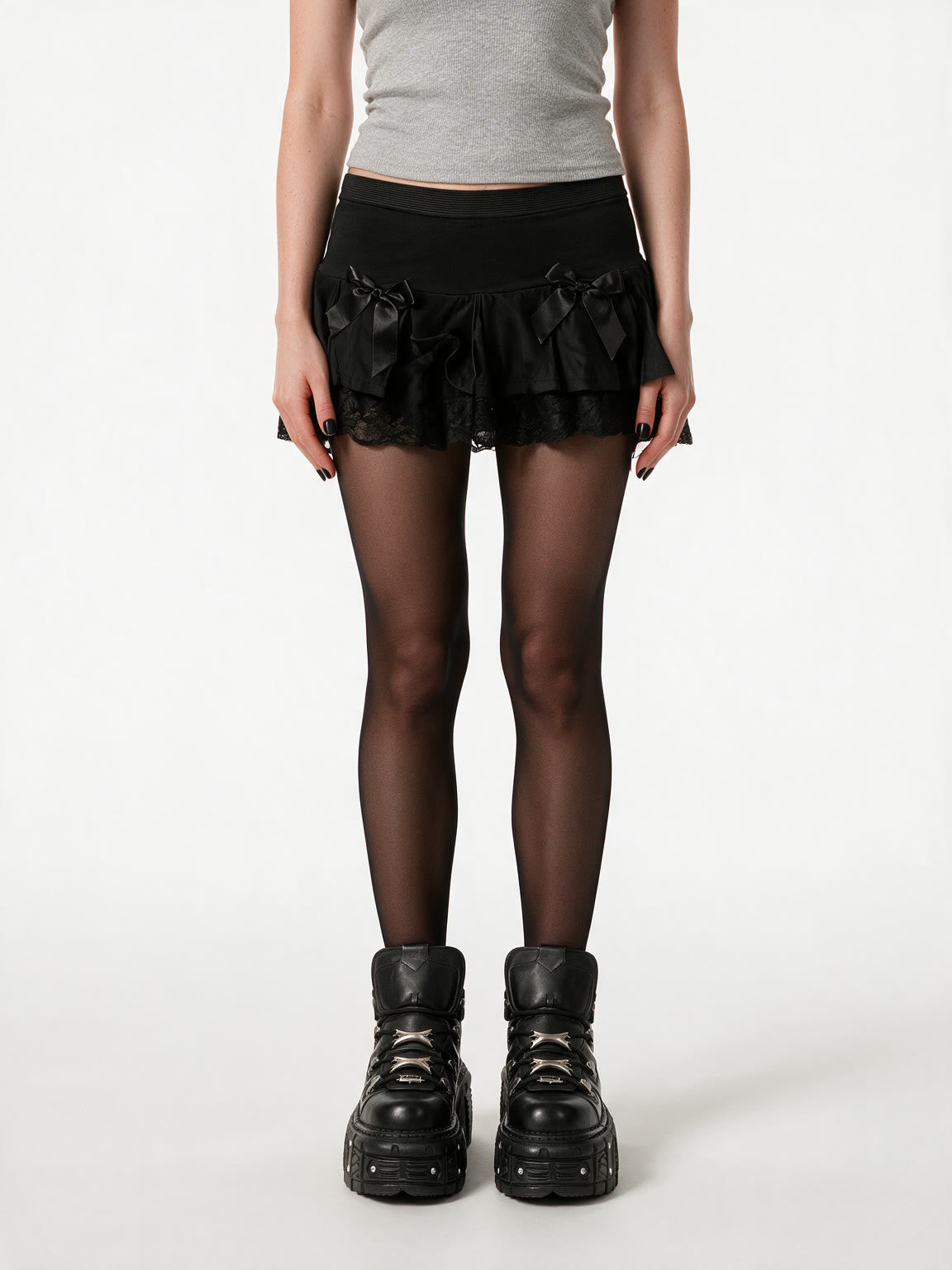 Black ruffle mini skirt with lace trim and satin bows