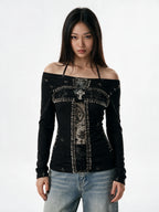 Black long sleeve top with a pinned lace panel and cross prints