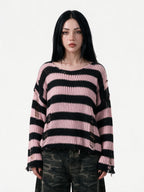 Oversized pink and black striped distressed knit sweater