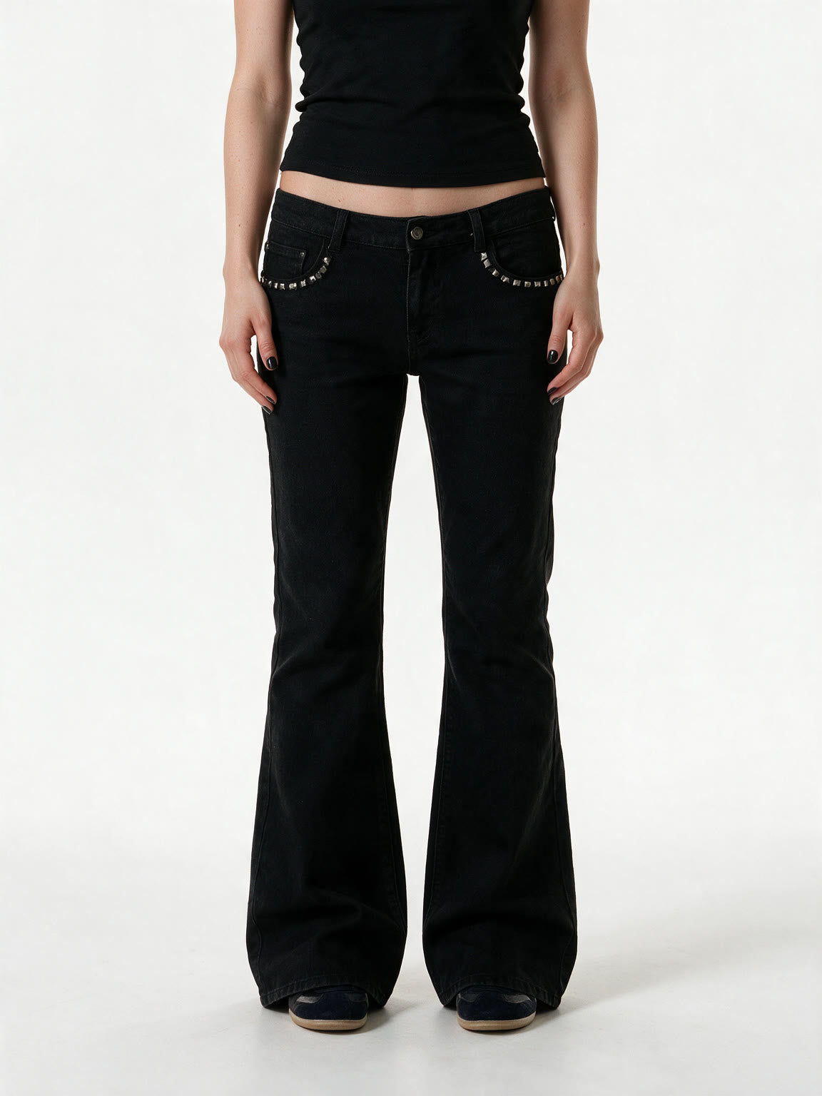 Black low rise flare jeans with a studded waistband