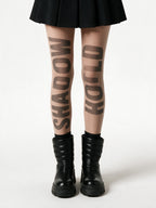Sheer nude tights with slogan lettering printed down the leg