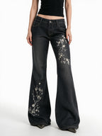 Washed black flare jeans with pale floral embroidery