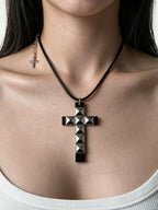 Black studded cross pendant on a cord necklace