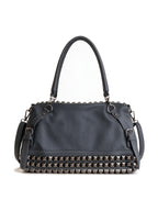 Grey studded moto bag with a silver cross emblem
