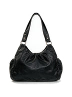 Black hobo bag covered in silver chains, skulls and spike charms