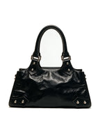 Black leather baguette bag with a large silver star and studs