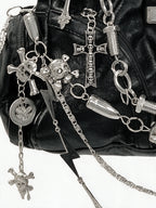 Black hobo bag covered in silver chains, skulls and spike charms
