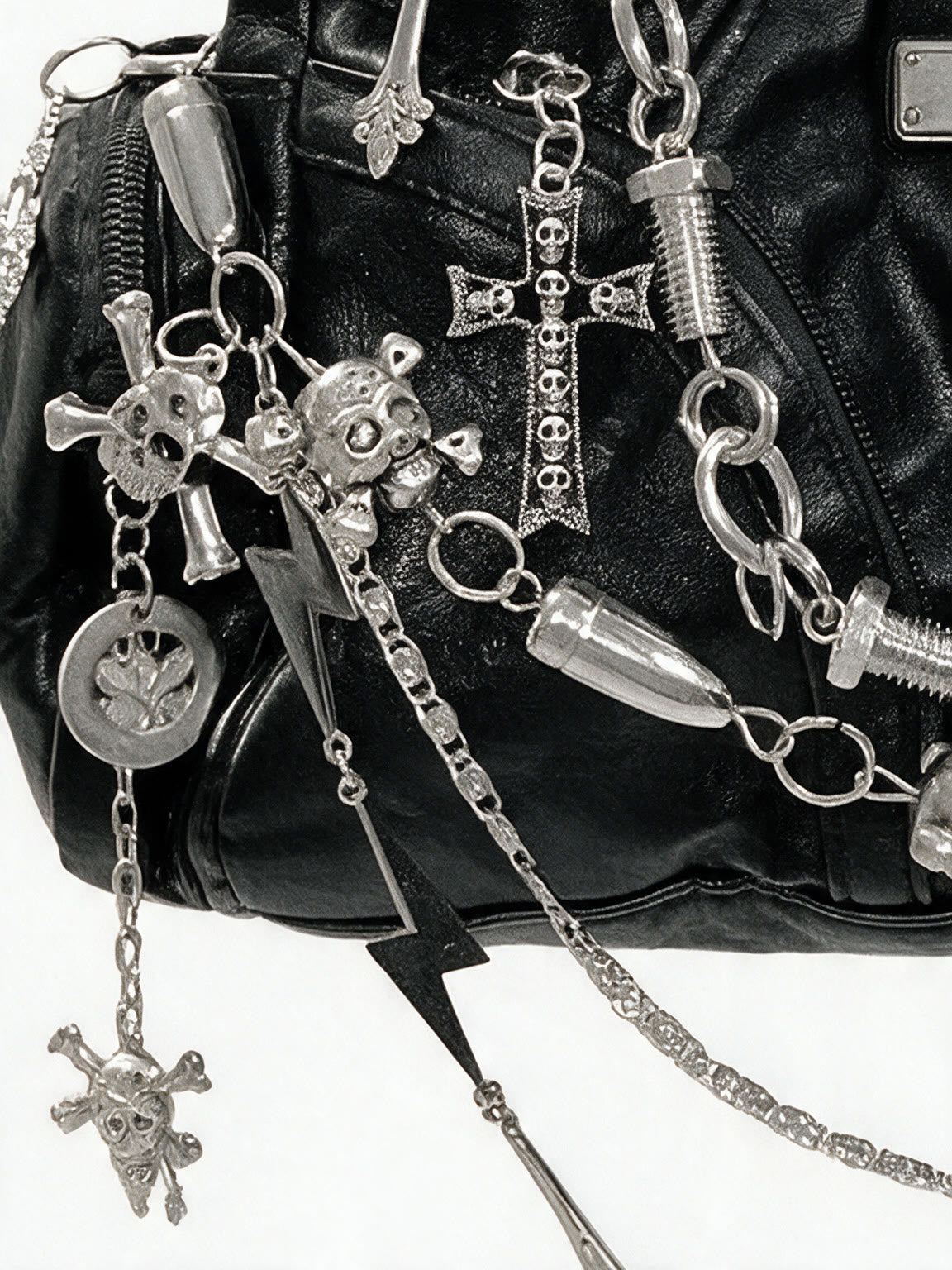 Black hobo bag covered in silver chains, skulls and spike charms