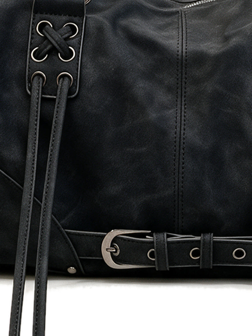 Black leather pillow shoulder bag with tassels and a front belt