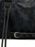 Black leather pillow shoulder bag with tassels and a front belt