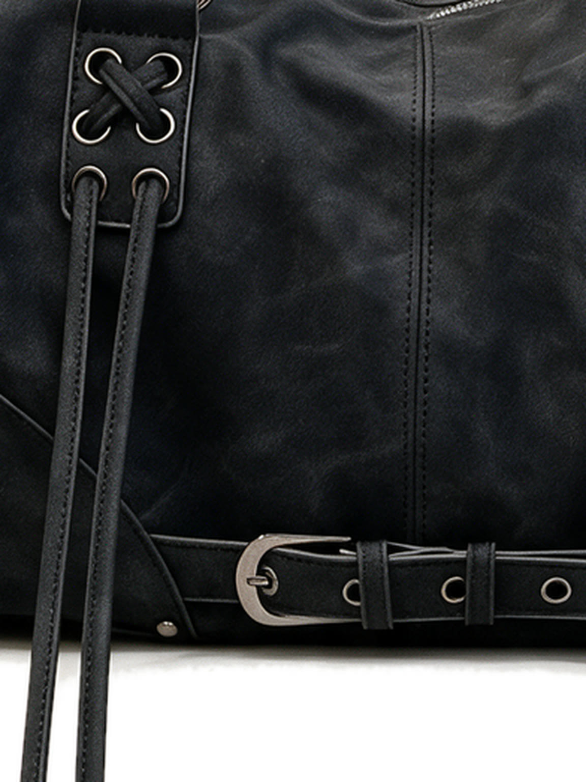 Black leather pillow shoulder bag with tassels and a front belt