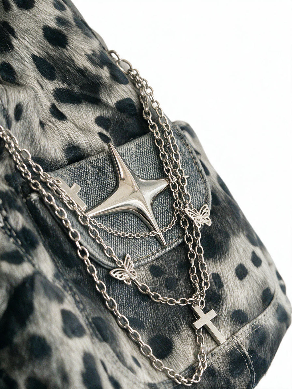 Grey leopard print hobo bag with silver chains and a star charm